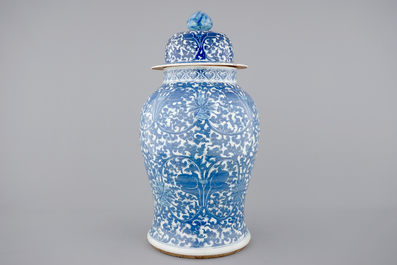 A tall blue and white Chinese porcelain vase and cover with lotus scrolls, 19th C.