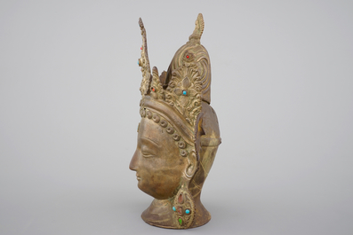 A tall gilt bronze head of a Boddhisatva with semi-precious stones, Tibet, 17/18th C.