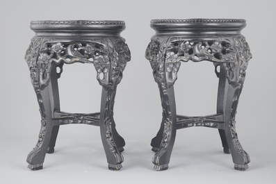 A pair of Chinese carved darkened wood vase stands with marble top, 20th C.