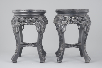 A pair of Chinese carved darkened wood vase stands with marble top, 20th C.