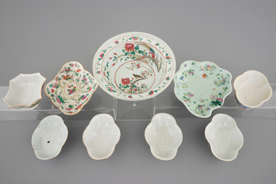 A Chinese famille rose basin with a bird on a branch and 8 smaller bowls, 19th C.