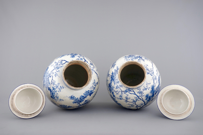 A tall pair of Japanese Arita porcelain blue and white vases and covers, ca. 1860