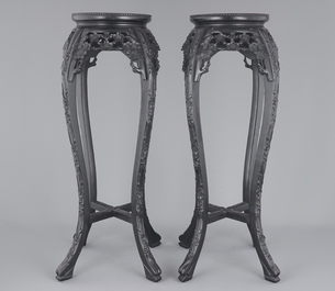 A tall pair of Chinese carved stands with marble top, 19th C.