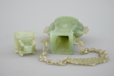 A Chinese carved green jadeite vase and cover on elaborate wooden stand, 19/20th C.