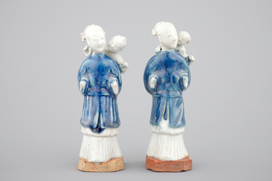 Two Chinese blue and white figures of a lady with child on biscuit base, Qianlong, 18th C.