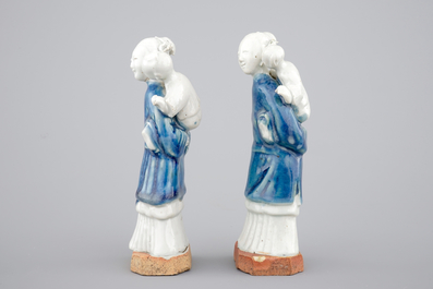 Two Chinese blue and white figures of a lady with child on biscuit base, Qianlong, 18th C.