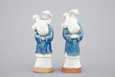 Two Chinese blue and white figures of a lady with child on biscuit base, Qianlong, 18th C.