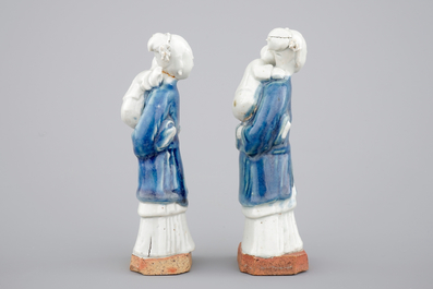 Two Chinese blue and white figures of a lady with child on biscuit base, Qianlong, 18th C.