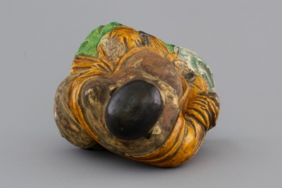 A Chinese sancai-glazed pottery Buddha, late Ming Dynasty