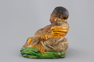 A Chinese sancai-glazed pottery Buddha, late Ming Dynasty