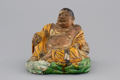 A Chinese sancai-glazed pottery Buddha, late Ming Dynasty