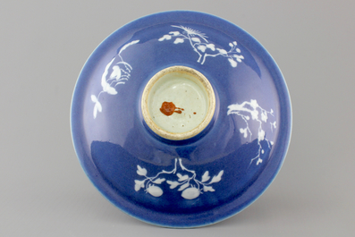 A Chinese porcelain monochrome blue ground plate with two bats, 19th C.