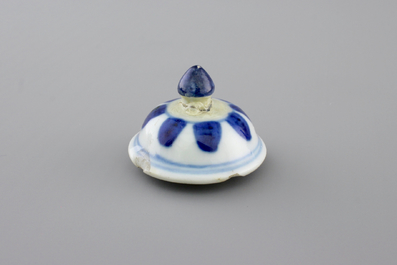 A Chinese blue and white porcelain candlestick and a miniature teapot, 18th C.