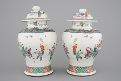 A pair of Chinese vases with covers with playing boys, 19th C.