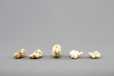 A set of 9 small Japanese ivory carvings, incl. netsuke, on a small red lacquer table, 19th/early 20th C.