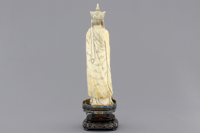 A fine Chinese carved ivory deity with an incense burner on a cloisonne and silver inlaid stand, 19th C.