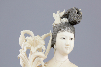 A finely carved Chinese ivory lady on wooden stand, ca. 1900