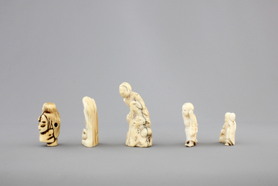 A set of 9 small Japanese ivory carvings, incl. netsuke, on a small red lacquer table, 19th/early 20th C.