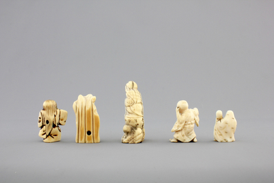 A set of 9 small Japanese ivory carvings, incl. netsuke, on a small red lacquer table, 19th/early 20th C.