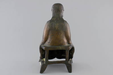 A Chinese bronze figure of an emperor on a throne, 18/19th C.