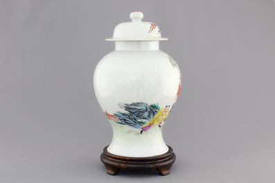 A Chinese famille rose porcelain vase with playing boys on a wooden stand, 19th C.