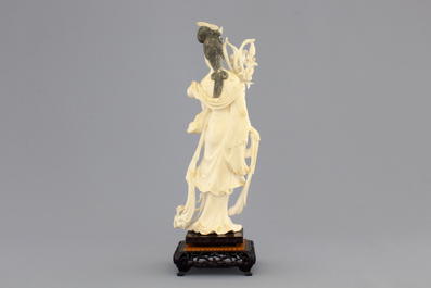 A finely carved Chinese ivory lady on wooden stand, ca. 1900