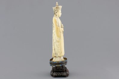 A fine Chinese carved ivory deity with an incense burner on a cloisonne and silver inlaid stand, 19th C.