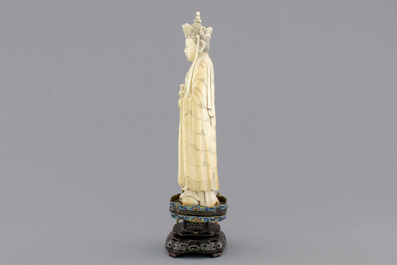 A fine Chinese carved ivory deity with an incense burner on a cloisonne and silver inlaid stand, 19th C.