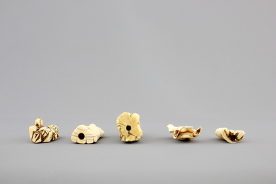 A set of 9 small Japanese ivory carvings, incl. netsuke, on a small red lacquer table, 19th/early 20th C.