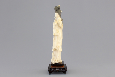 A finely carved Chinese ivory lady on wooden stand, ca. 1900