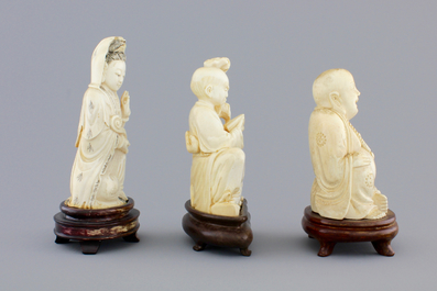 Three Chinese carved ivory figures on wooden stands, ca. 1900