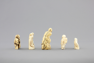 A set of 9 small Japanese ivory carvings, incl. netsuke, on a small red lacquer table, 19th/early 20th C.