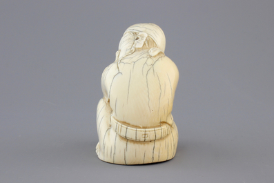 A Chinese carved ivory figure of a sage, signed, 19th C.