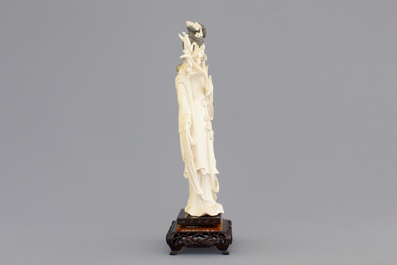 A finely carved Chinese ivory lady on wooden stand, ca. 1900