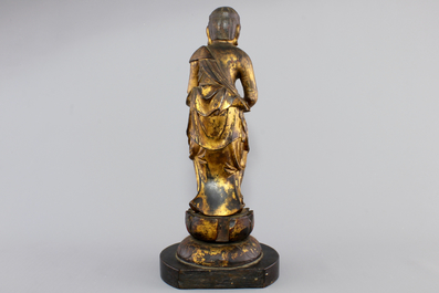 A Chinese gilt and laquered wood figure of a female deity, 18/19th C.