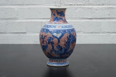 A Chinese porcelain underglaze red and blue dragon vase, 19th C.
