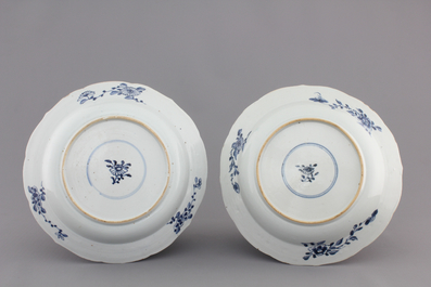 A pair of blue and white Chinese porcelain plates with a vase in a garden, Qianlong, 18th C.