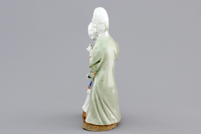 A Chinese celadon and blue-white biscuit group of a couple, Qianlong, 18th C.