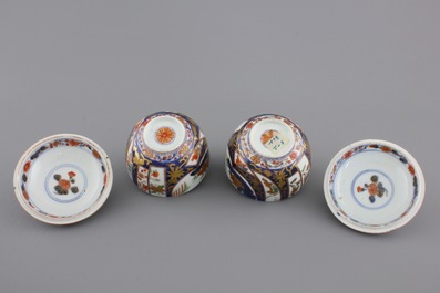 A pair of Japanese Imari porcelain cups and covers on stand, 18th C.