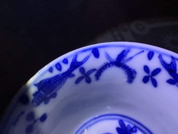 A set of six Chinese blue and white cups and saucers with fish, 19th C.