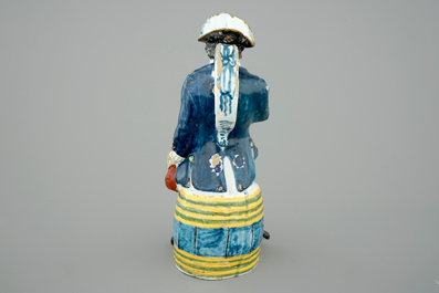 A tall dated Brussels faience jug modelled as a man on a barrel, 18th C.