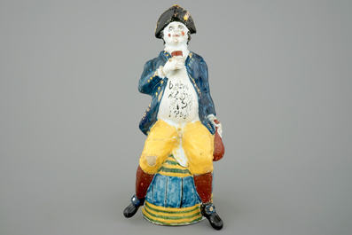 A tall dated Brussels faience jug modelled as a man on a barrel, 18th C.