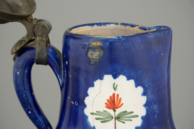 A Brussels faience jug with a drinking man, late 18th C.