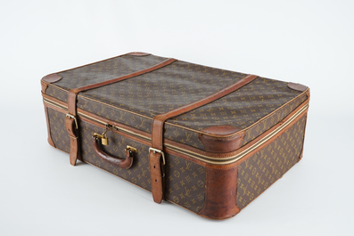 A Louis Vuitton leather travel suitcase, mid 20th C.