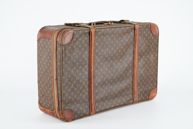 A Louis Vuitton leather travel suitcase, mid 20th C.