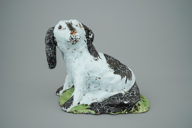 A polychrome Brussels faience model of a dog, 18th C.