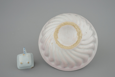 A white Dutch Delft baking mold and a miniature cup, 18th C.