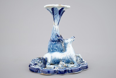 A blue and white Dutch Delft candlestick with a deer and a buddhist, 18th C.