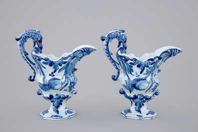 A pair of blue and white Dutch Delft helmet-shaped jugs, 18th C.