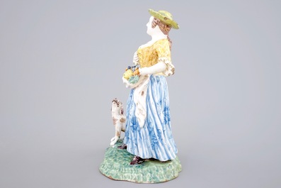 A tall polychrome pottery group of a lady with a dog, Nevers, 18th C.